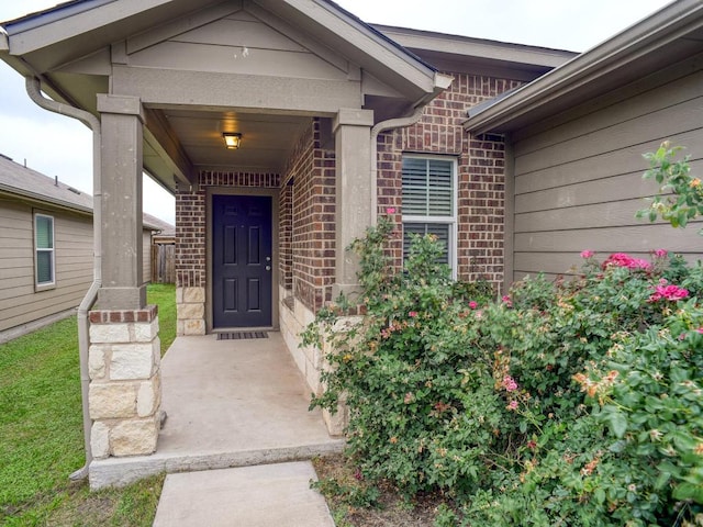 property entrance featuring brick siding