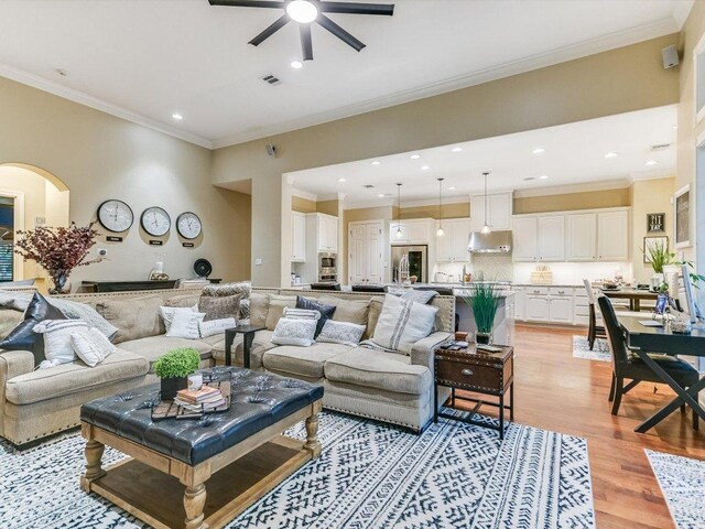 5709 Laguna Cliff Ln, Austin, TX 78734 - living room with a ceiling fan, light wood-style floors, ornamental molding, recessed lighting, and arched walkways