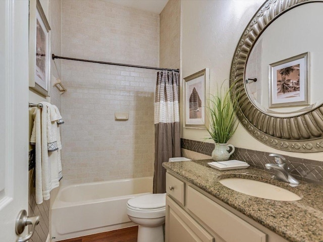 bathroom with toilet, wood finished floors, shower / bath combo, and vanity