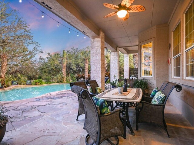 5709 Laguna Cliff Ln, Austin, TX 78734 - patio terrace at dusk featuring a patio, a ceiling fan, and an outdoor pool