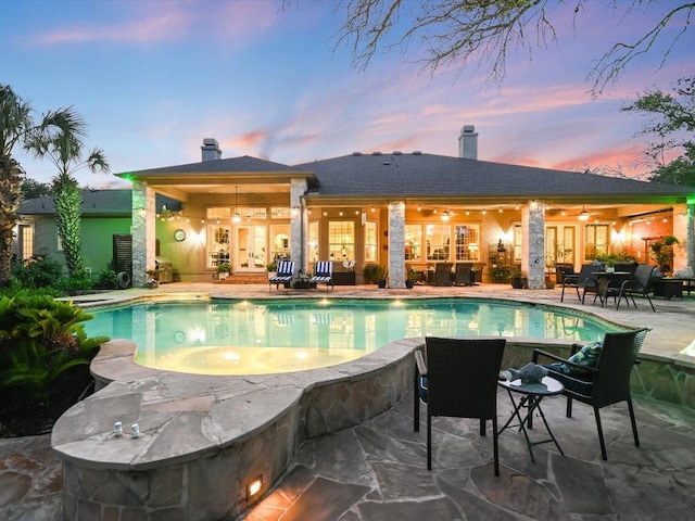 outdoor pool with a patio, ceiling fan, and french doors