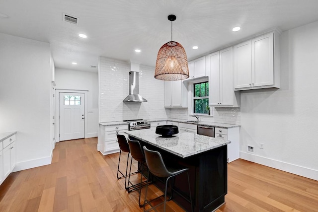 1200 Woodlawn St, Lockhart, TX 78644 - kitchen with wall chimney exhaust hood, stainless steel appliances, baseboards, tasteful backsplash, and recessed lighting