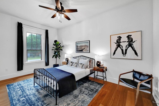 1200 Woodlawn St, Lockhart, TX 78644 - bedroom featuring wood finished floors, baseboards, and a ceiling fan
