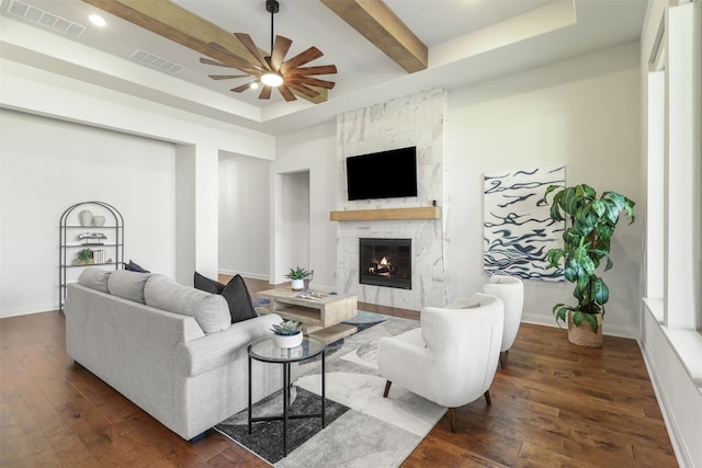 living room with a ceiling fan, visible vents, and dark wood-style floors