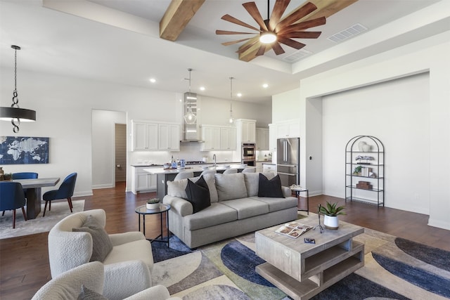 living area with dark wood-style flooring, visible vents, and recessed lighting