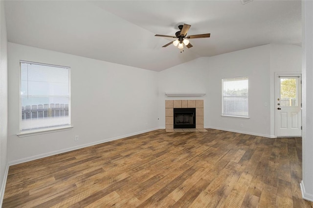 15205 Bullace St, Austin, TX 78724 - unfurnished living room with hardwood / wood-style floors, lofted ceiling, a tile fireplace, ceiling fan, and baseboards