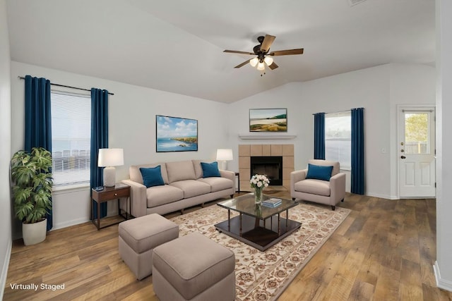 15205 Bullace St, Austin, TX 78724 - living room featuring lofted ceiling, hardwood / wood-style flooring, a ceiling fan, plenty of natural light, and a tile fireplace