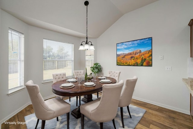15205 Bullace St, Austin, TX 78724 - dining space with lofted ceiling, wood finished floors, baseboards, a chandelier, and healthy amount of natural light