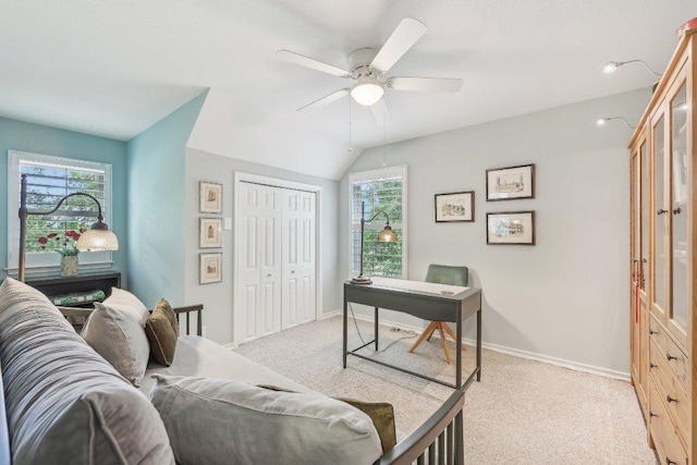 office space featuring plenty of natural light, light carpet, and ceiling fan
