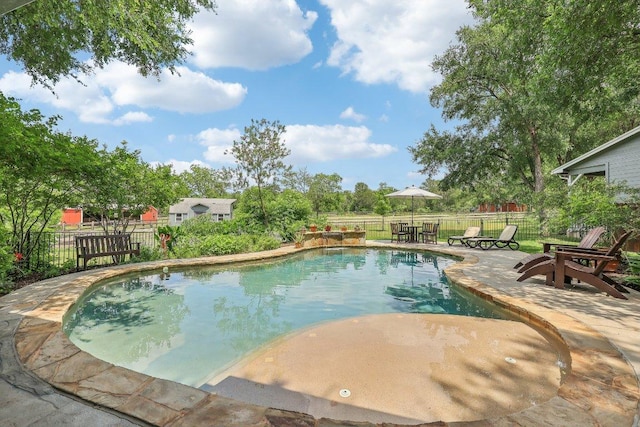view of swimming pool featuring a patio, a fenced in pool, and a fenced backyard