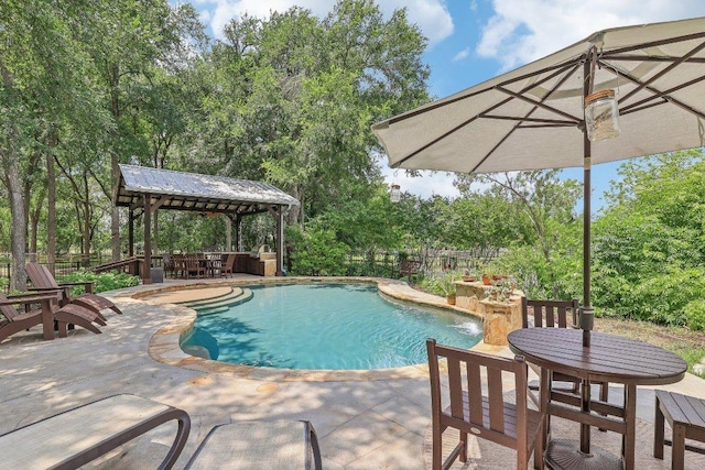 pool featuring fence, a patio, and a gazebo