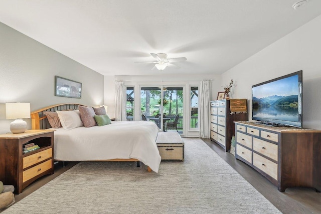 bedroom with a ceiling fan, wood finished floors, and access to exterior