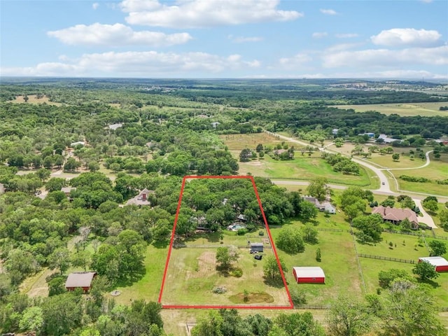 birds eye view of property featuring a view of trees