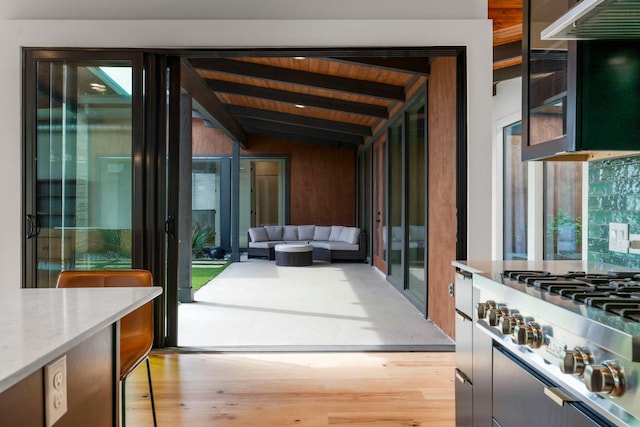 doorway to outside with french doors, lofted ceiling with beams, light wood-style floors, and wooden ceiling
