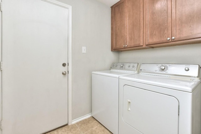 2206 Weiss Ln, Georgetown, TX 78626 - laundry area with washer and clothes dryer, cabinet space, baseboards, and light tile patterned flooring