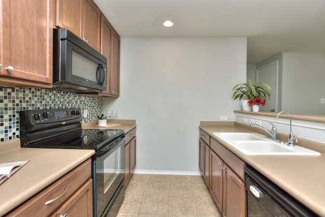 2206 Weiss Ln, Georgetown, TX 78626 - kitchen featuring black appliances, a sink, tasteful backsplash, light countertops, and baseboards