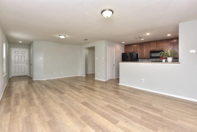 2206 Weiss Ln, Georgetown, TX 78626 - unfurnished living room with light wood finished floors, baseboards, and recessed lighting