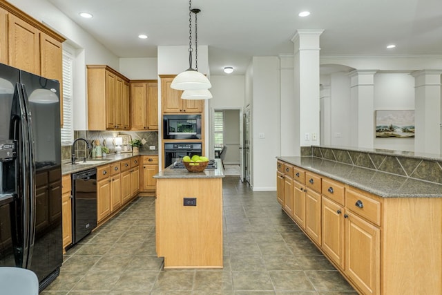 kitchen featuring decorative backsplash, a kitchen island, ornate columns, a sink, and black appliances