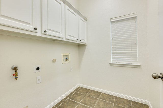 washroom with baseboards, dark tile patterned floors, gas dryer hookup, cabinet space, and hookup for an electric dryer