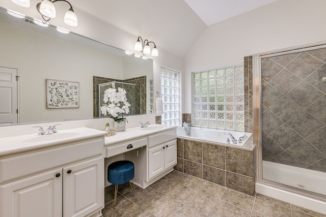 full bathroom with double vanity, a garden tub, a stall shower, a sink, and lofted ceiling