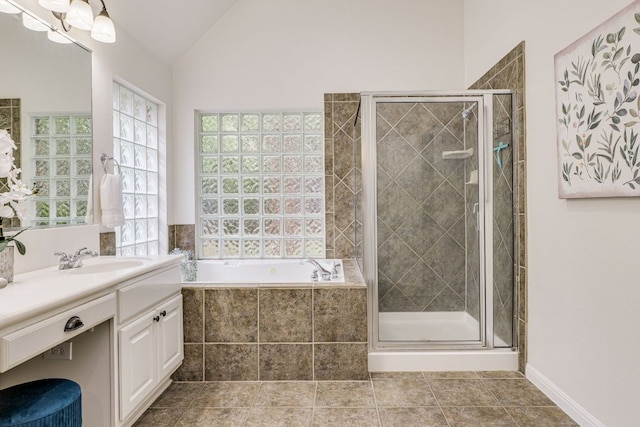 2408 Tivoli Dr, Cedar Park, TX 78613 - bathroom with plenty of natural light, vanity, a garden tub, a shower stall, and lofted ceiling