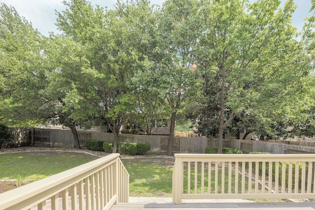 deck with a fenced backyard and a yard