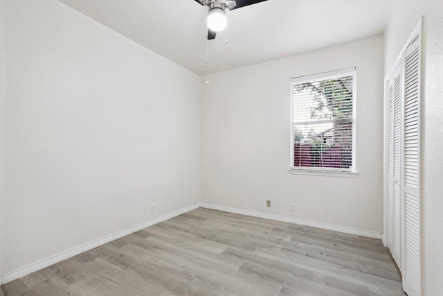 unfurnished room featuring baseboards, ceiling fan, and light wood-style flooring