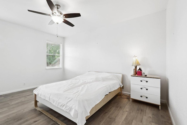 bedroom with baseboards, a ceiling fan, and wood finished floors