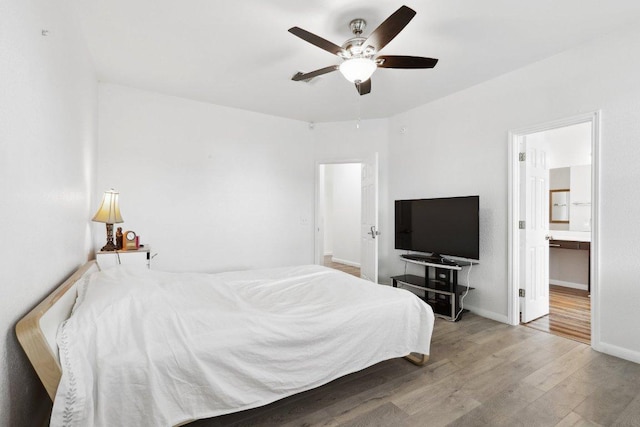 8117 Manx Dr, Round Rock, TX 78681 - bedroom with wood finished floors, connected bathroom, and a ceiling fan