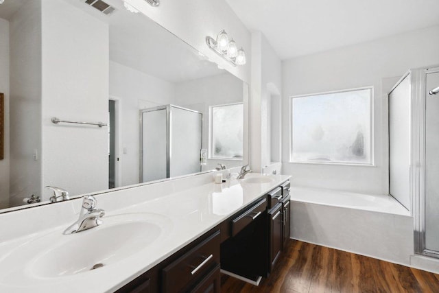 8117 Manx Dr, Round Rock, TX 78681 - full bathroom with a shower stall, a bath, double vanity, and wood finished floors