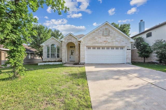 8117 Manx Dr, Round Rock, TX 78681 - view of front of home featuring stone siding, concrete driveway, an attached garage, and a front lawn