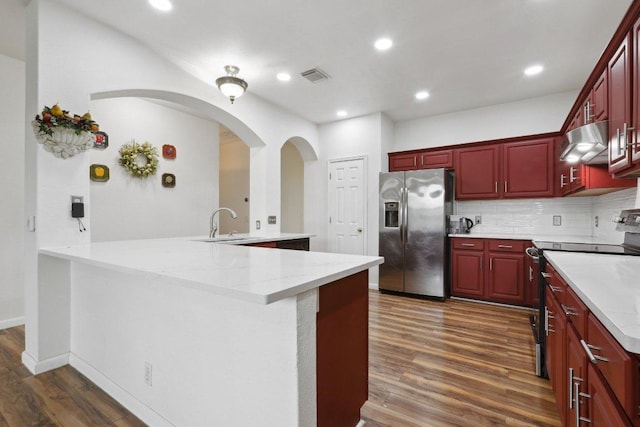8117 Manx Dr, Round Rock, TX 78681 - kitchen featuring stainless steel refrigerator with ice dispenser, range with electric cooktop, reddish brown cabinets, exhaust hood, and dark wood finished floors