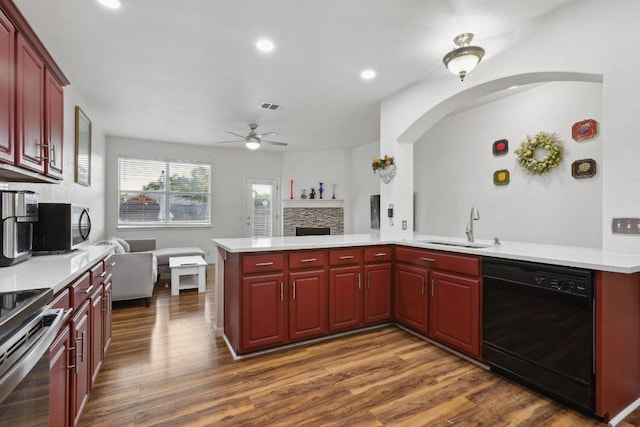 kitchen with a ceiling fan, visible vents, a sink, reddish brown cabinets, and stainless steel appliances
