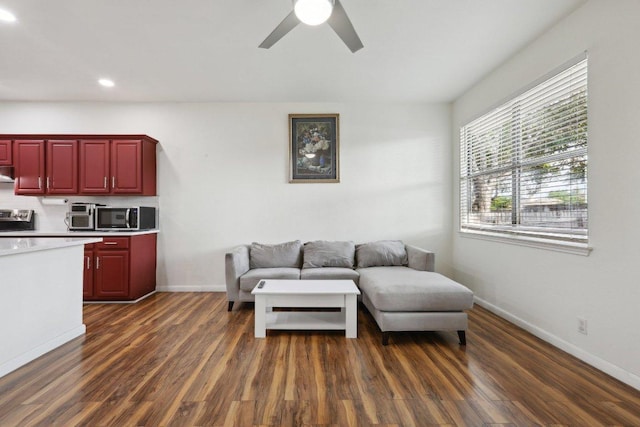 living room featuring dark wood-style flooring, ceiling fan, recessed lighting, and baseboards