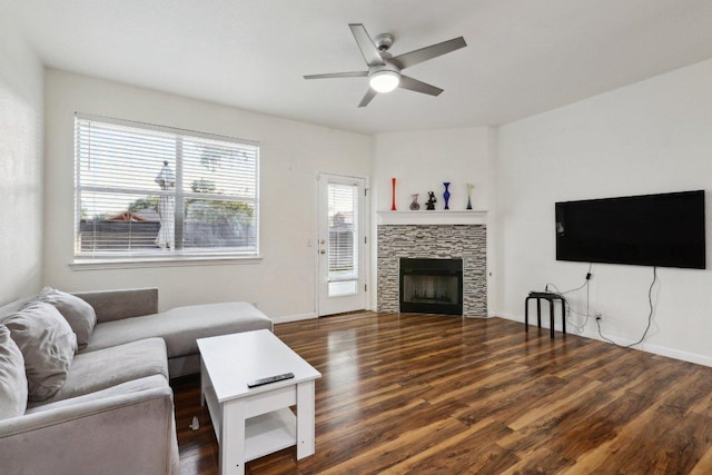 8117 Manx Dr, Round Rock, TX 78681 - living area featuring wood finished floors, a ceiling fan, and a stone fireplace