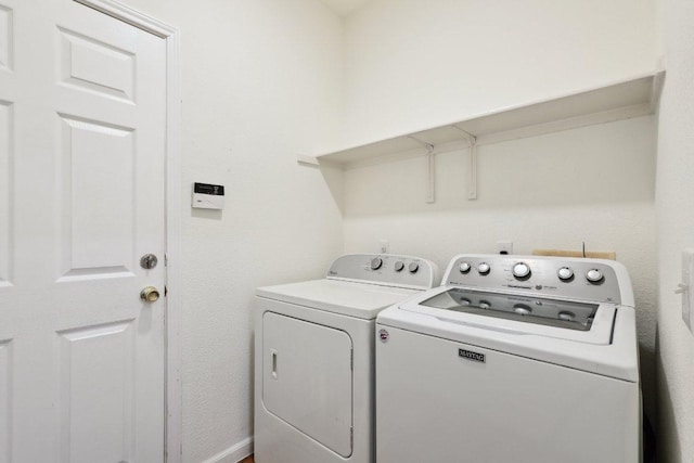 clothes washing area featuring laundry area and washing machine and dryer