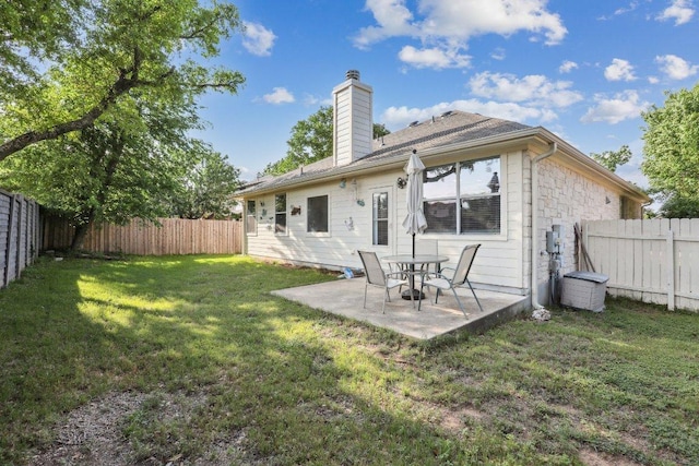8117 Manx Dr, Round Rock, TX 78681 - rear view of house featuring a chimney, a fenced backyard, a patio area, and stone siding