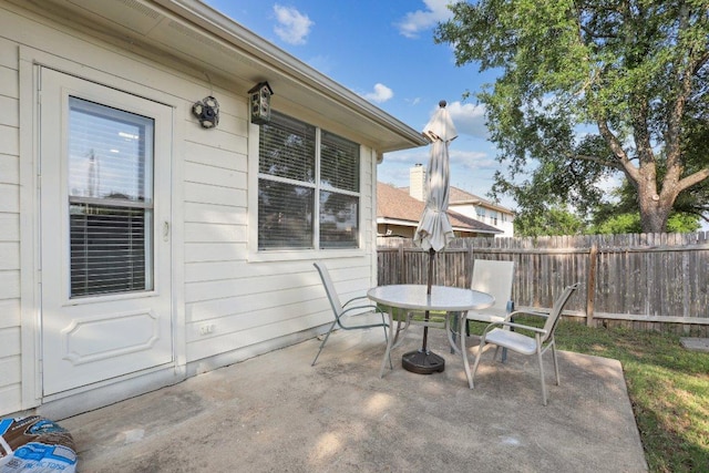 view of patio with fence and outdoor dining area