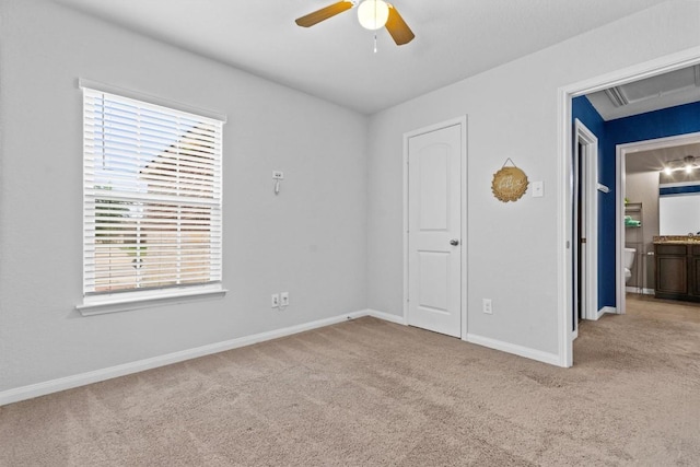 unfurnished bedroom with baseboards, carpet flooring, multiple windows, and attic access