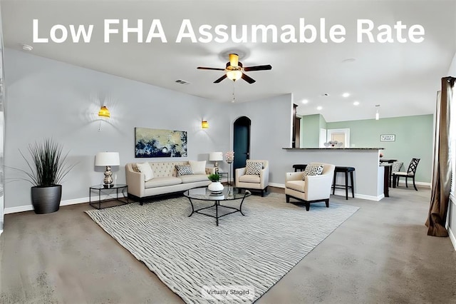 13516 William Mckinley Way, Manor, TX 78653 - living room featuring concrete flooring, arched walkways, baseboards, ceiling fan, and recessed lighting