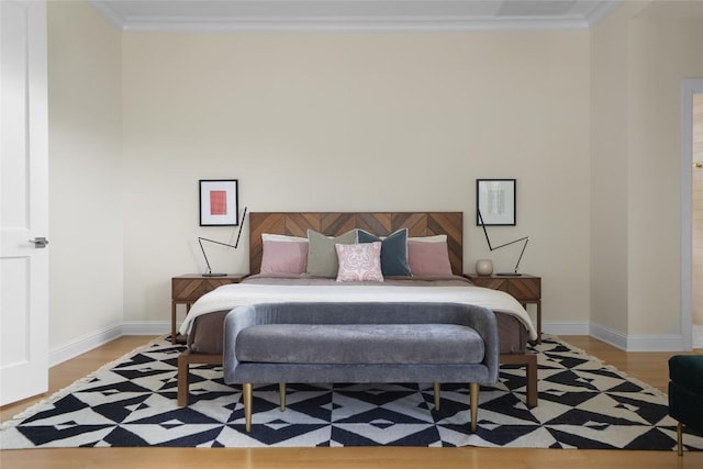 bedroom with baseboards, ornamental molding, and light wood-type flooring