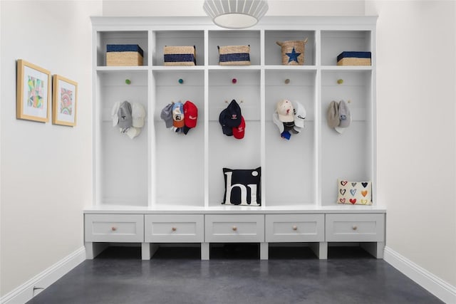 mudroom with finished concrete floors and baseboards