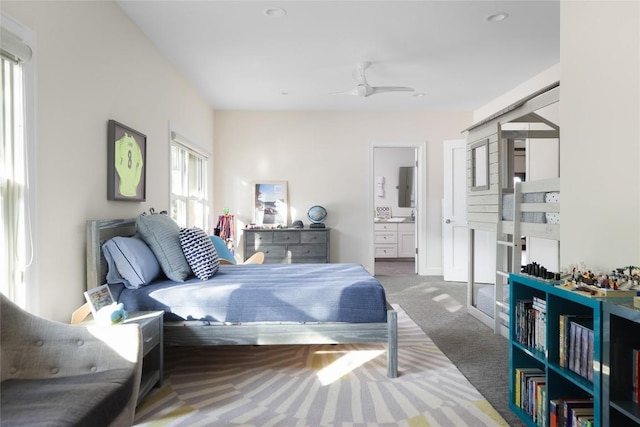 bedroom featuring connected bathroom, recessed lighting, and carpet
