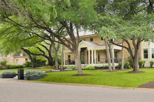 400 Almarion Dr, Austin, TX 78746 - view of front of house with a standing seam roof, a front yard, metal roof, and stone siding