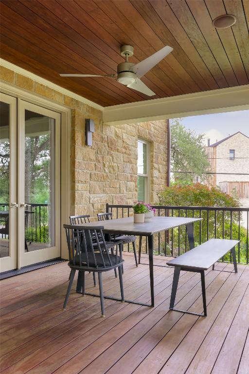 wooden deck featuring outdoor dining area and ceiling fan
