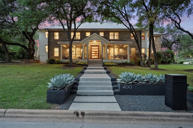 400 Almarion Dr, Austin, TX 78746 - view of front of home with a standing seam roof, a yard, stone siding, and a porch