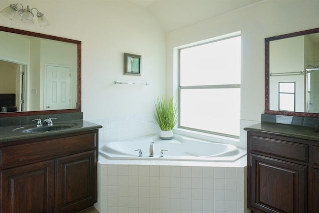 112 Bearing Cv, Austin, TX 78717 - bathroom featuring two vanities, a healthy amount of sunlight, a sink, and a garden tub