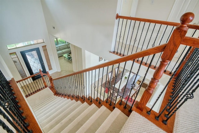 112 Bearing Cv, Austin, TX 78717 - stairs featuring a high ceiling and carpet