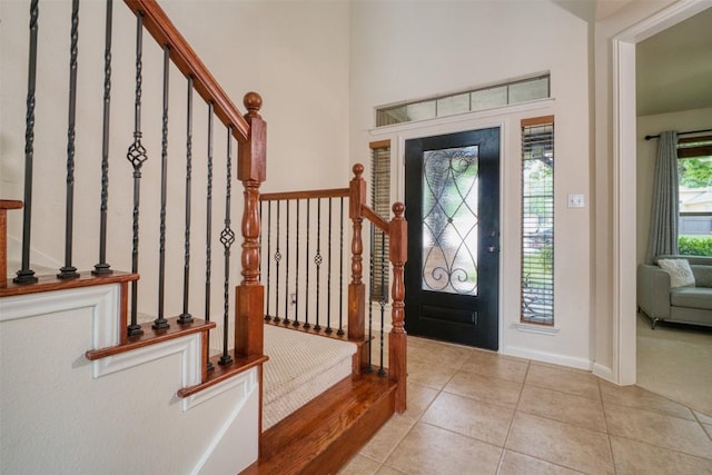 112 Bearing Cv, Austin, TX 78717 - entryway with baseboards, stairs, and light tile patterned flooring