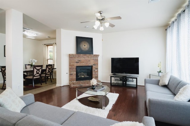 112 Bearing Cv, Austin, TX 78717 - living area featuring a brick fireplace, ceiling fan, baseboards, and wood finished floors